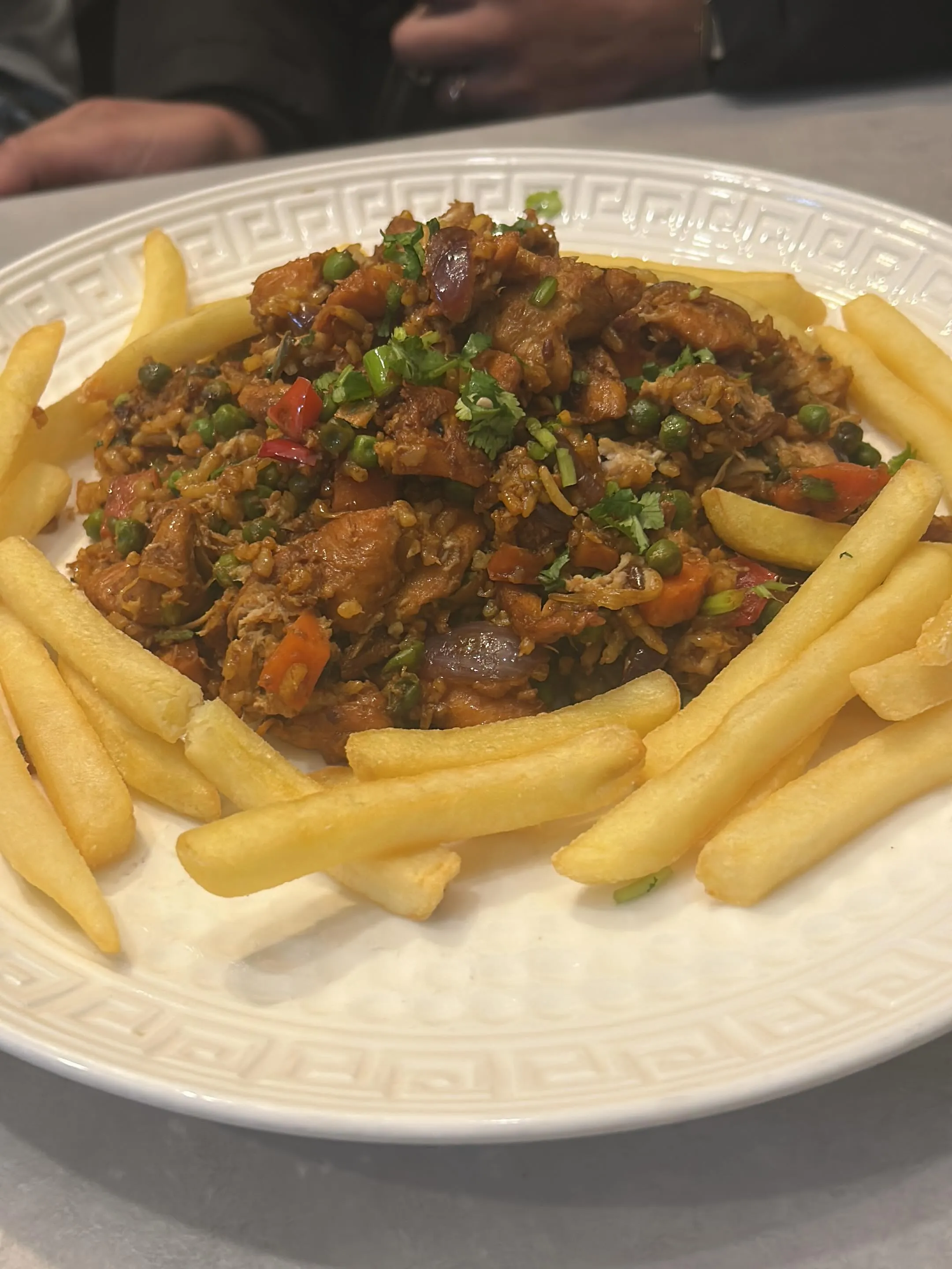 Arroz con pollo, los geschept, met een ring friet eromheen. Hoogste resolutie van de set